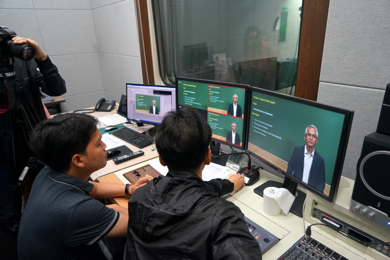 라오스 관계자에게 강의 촬영 현장을 설명하는 모습